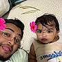 Kiannsha joined the competition — help win amazing prizes! adult, baby, child, glasses_filter, flower_filter, selfie, lying_down, patterned_background, face, person, indoors, casual_clothing, expression, cute, fun, black_hair, skin_tone, digital_filter, portrait, family