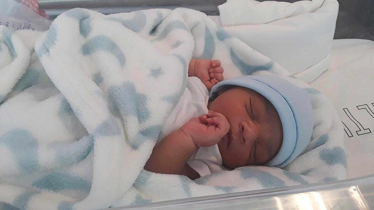 Raphael is registered to the contest to win money with this photo: newborn, baby, sleeping, blanket, hat, hospital, bassinet, infant, soft, cozy, wrapped, peaceful, cute, child, portrait, resting, blue, white, newborn_baby, toddler