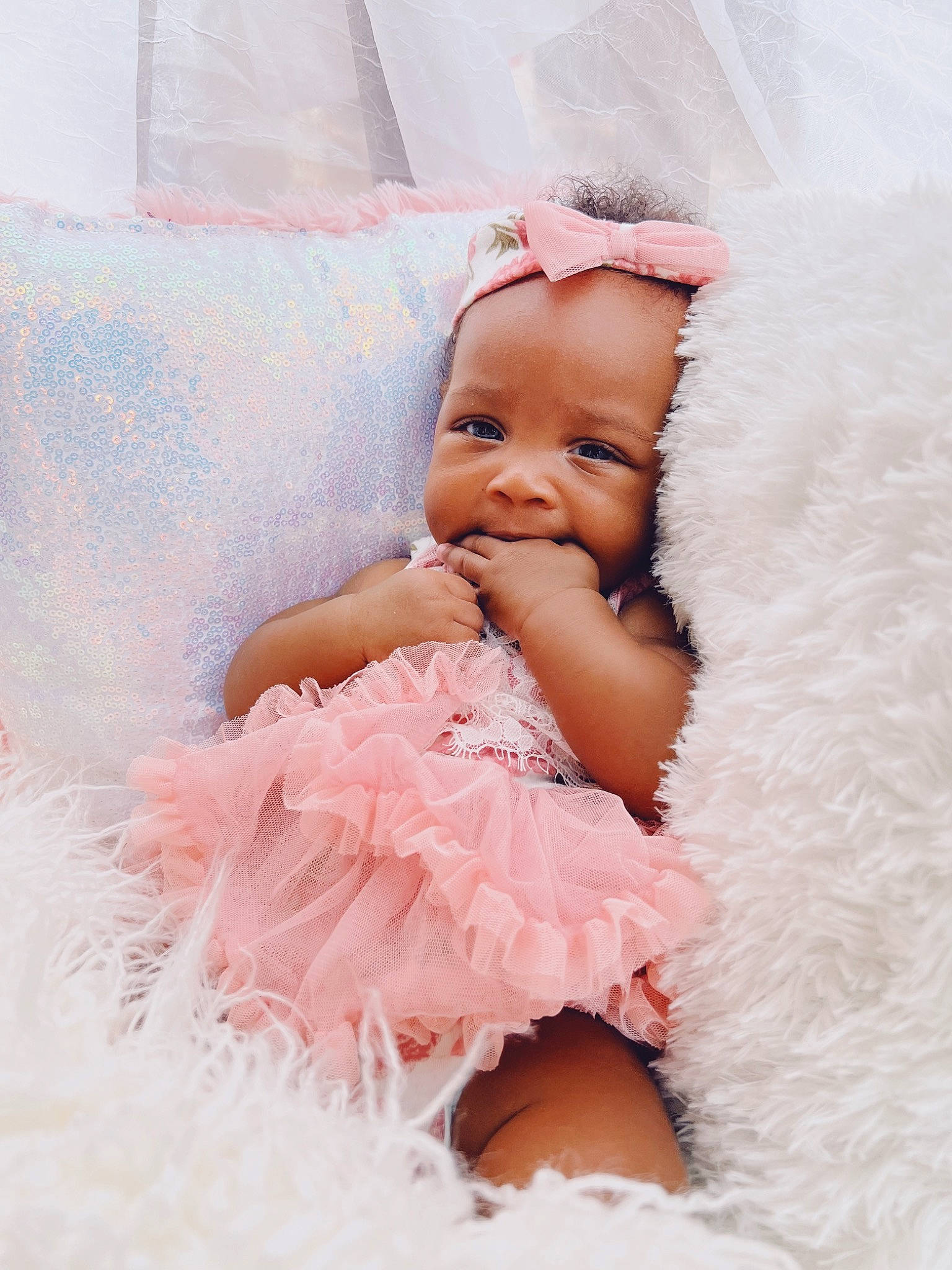 Beau is registered to the contest to win money with this photo: baby, baby_toddler_clothing, bridal_accessory, comfort, dress, embellishment, event, face, flash_photography, happy, headpiece, linens, magenta, peach, person, pink, ruffle, skin, smile, textile