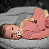 Devyn is registered to the contest to win money with this photo: adorable, baby, black_and_white, blanket, brown_hair, child, close_up, cozy, eyes, face, fluffy_blanket, indoor, infant, lying_down, nursery, pacifier, pink_outfit, portrait, selective_color, sleepwear