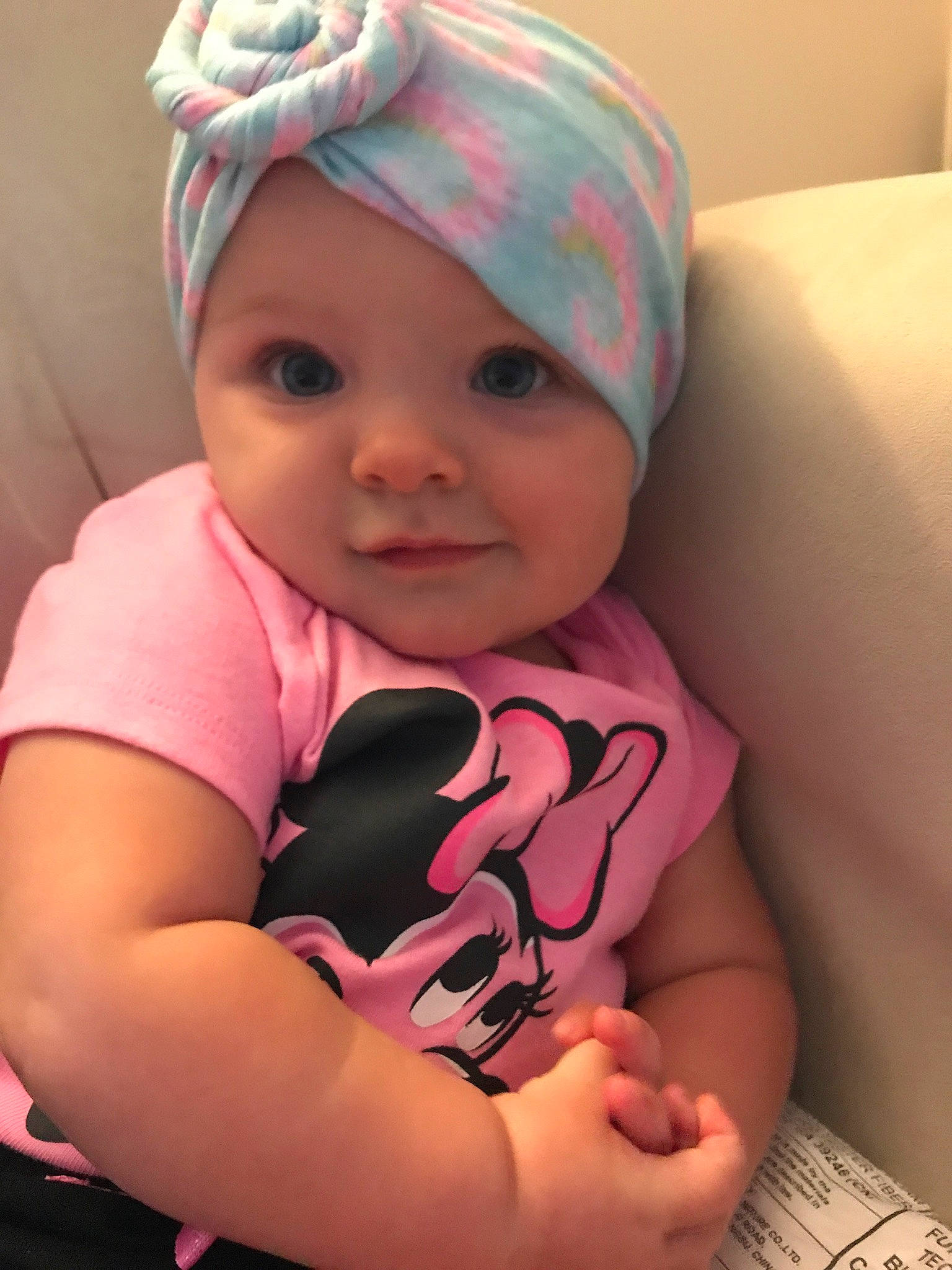 Harlee is registered to the contest to win money with this photo: arm, baby, baby_toddler_clothing, cap, cheek, comfort, cool, eye, finger, happy, headgear, headwear, lip, mouth, neck, nose, person, pink, purple, skin