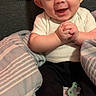 baby, smiling, infant, blanket, pacifier, hands, clothing, cute, happy, indoor, person, face, feet, sitting, portrait, young_child, head, expression, cozy, child
