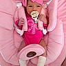 Zoe is registered to the contest to win money with this photo: baby, infant, child, portrait, pink, headband, pacifier, baby_seat, car_seat, sitting, awake, clothing, onesie, socks, blanket, cushion, indoor, close_up, face, smiling
