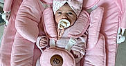 Zoe joined the competition — help win amazing prizes! baby, infant, child, pink, bouncer, baby_chair, pacifier, headband, bow, stuffed_animal, shark_toy, star_toy, blanket, harness, knitwear, socks, lying_down, portrait, indoor, cute