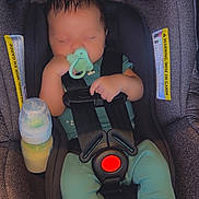 Zyon is registered to the contest to win money with this photo: baby, infant, car_seat, pacifier, sleeping, bottle, clothing, footwear, straps, child, seat_belt, indoor, cute, peaceful, newborn, resting, soft_lighting, close_up, person, transport