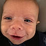 baby, face, smile, eyes, close_up, infant, expression, joy, child, skin, head, clothing, blanket, warmth, cute, portrait, young, person, happy, indoors