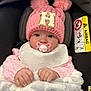 baby, infant, pacifier, pink_hat, knitted_hat, pom_poms, blanket, car_seat, airbag_warning, clothing, cute, child, face, hands, warm, cozy, indoor, portrait, sitting, wrapped
