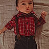 Zayne is registered to the contest to win money with this photo: baby, bedspread, casual, child, curious_expression, cute, eyes, face, fashion, hands, indoors, infant, lying_down, pants, person, plaid_shirt, portrait, spiky_hair, suspenders, young_child