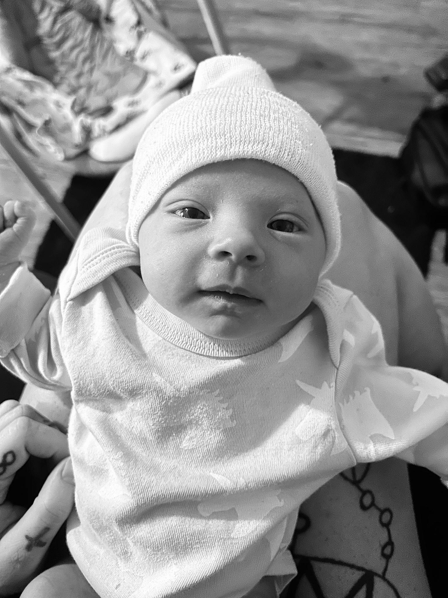 Everleigh joined the competition — help win amazing prizes! baby, black, black_and_white, cap, cheek, eye, facial_expression, gesture, hairstyle, happy, headgear, interaction, lip, person, photograph, skin, sleeve, standing, style, toddler