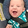baby, child, car_seat, smiling, happy, infant, seatbelt, clothing, blue, padding, safety, cute, portrait, young, person, hand, face, indoor, seat, expression