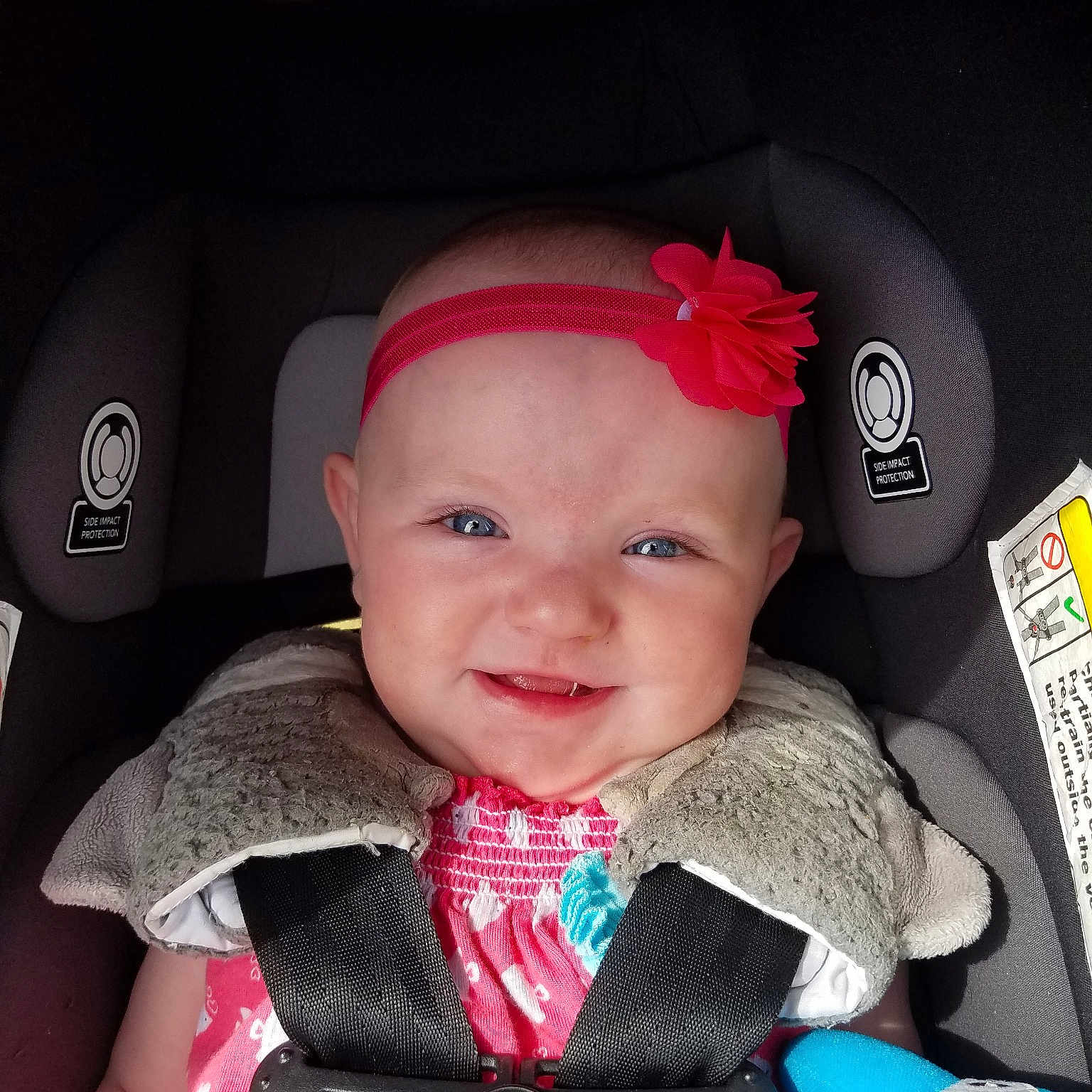 Maisie is registered to the contest to win money with this photo: auto_part, baby, baby_carriage, baby_in_car_seat, baby_products, car_seat, cheek, child, hair_accessory, head, headgear, person, pink, product, toddler