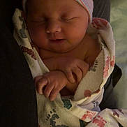 Jasmine is registered to the contest to win money with this photo: newborn, baby, infant, sleeping, swaddled, hat_with_bow, bow, hospital_blanket, footprints, blanket, hand, closed_eyes, peaceful, tiny_hand, parent_arm, portrait, closeup, indoor, soft_lighting, skin