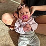 Kleo is registered to the contest to win money with this photo: baby, bow, carpet, casual, child, clothing, comfort, cute, hands, home, indoor, legs, light, pacifier, person, relaxed, shadow, sitting, soft, young_child