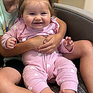 Kleo joined the competition — help win amazing prizes! baby, child, smiling, pink_clothing, heart_pattern, sitting, chair, happy, hands, legs, feet, hair_bows, indoor, person, holding, cute, family, toddler, face, closeup