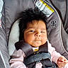 baby, car_seat, child, infant, seatbelt, straps, hair, face, indoors, clothing, pink, expression, serious, car, window, safety, graco, warning_label, person, young