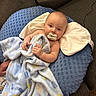 baby, blanket, pacifier, pillow, couch, infant, child, indoor, comfort, soft_texture, blue, brown, resting, person, portrait, relaxing, hand, face, head, cozy