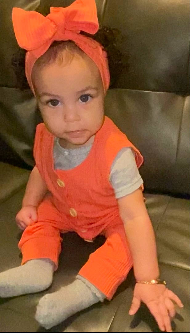 Emberlynn is registered to the contest to win money with this photo: baby, baby_toddler_clothing, cap, cheek, child, chin, comfort, cool, eye, face, finger, head, lip, mouth, nose, orange, person, pink, skin, sleeve