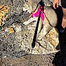 Luna participe au concours pour gagner de l'argent avec cette photo : puppy, dog, pink_harness, leash, rock, outdoor, sunlight, person, legs, arm, shadow, fur, pet, animal, walking, nature, summer, resting, canine, ground