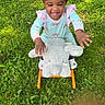 child, toddler, grass, outdoor, toy, plush_elephant, rocking_toy, happy, smiling, colorful_hair_beads, greenery, play, cute, pastel_clothing, footwear, sunlight, nature, fun, joy, baby