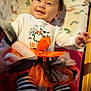 baby, child, smiling, halloween, tutu, striped_leggings, headband, blanket, footprints, costume, black_shoes, orange, white_shirt, cute, infant, happy, indoors, person, toddler, festive