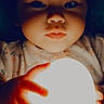 Elora joined the competition — help win amazing prizes! baby, child, glowing_orb, hands, face, dark_background, curious, soft_light, portrait, infant, night, expression, cute, indoor, lighting, skin, clothing, small_hands, mystical, closeup