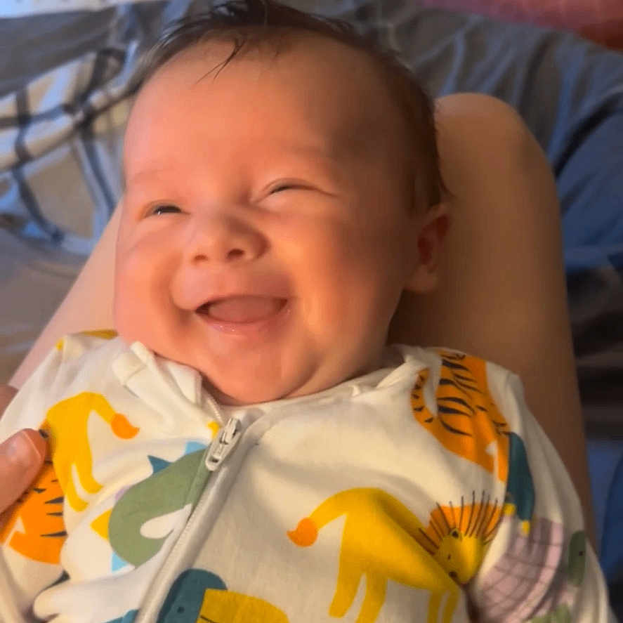 Luka joined the competition — help win amazing prizes! animal_print, baby, bedroom, blanket, child, comfort, cozy, cute, face, happy, indoor, infant, onesie, person, pillow, portrait, sleepwear, smiling, soft_lighting, young_child