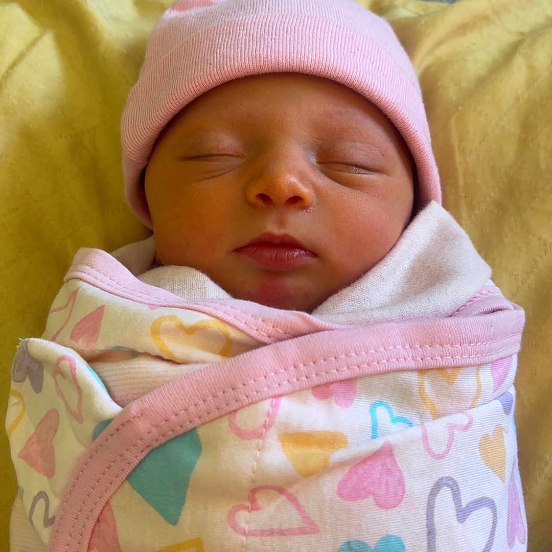 Elsie is registered to the contest to win money with this photo: baby, beanie, bed, blanket, bonnet, cap, clothing, face, furniture, glove, hat, head, hood, newborn, person, photography, portrait, quilt, sleeping, towel