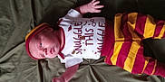 Jaythan is registered to the contest to win money with this photo: baby, casual, child, clothing, cute, expression, fabric, face, green_background, hat, indoors, infant, lying_down, newborn, onesie, person, portrait, small_hands, soft_light, striped_pants