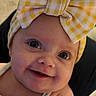 Willow is registered to the contest to win money with this photo: baby, child, smile, headband, yellow, white, bow, cute, portrait, infant, closeup, happy, face, eyes, clothing, soft_lighting, skin, innocence, expression, young