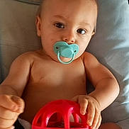 Hayden participe au concours pour gagner de l'argent avec cette photo : baby, blue, chair, child, colorful, comfort, cute, eyes, face, green, hands, indoors, infant, pacifier, person, play, red, skin, soft, toy