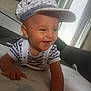 baby, blanket, cap, child, clothing, crawling, curtains, cute, face, happy, headwear, home, indoor, joyful, person, smiling, sofa, striped_shirt, window, young_child