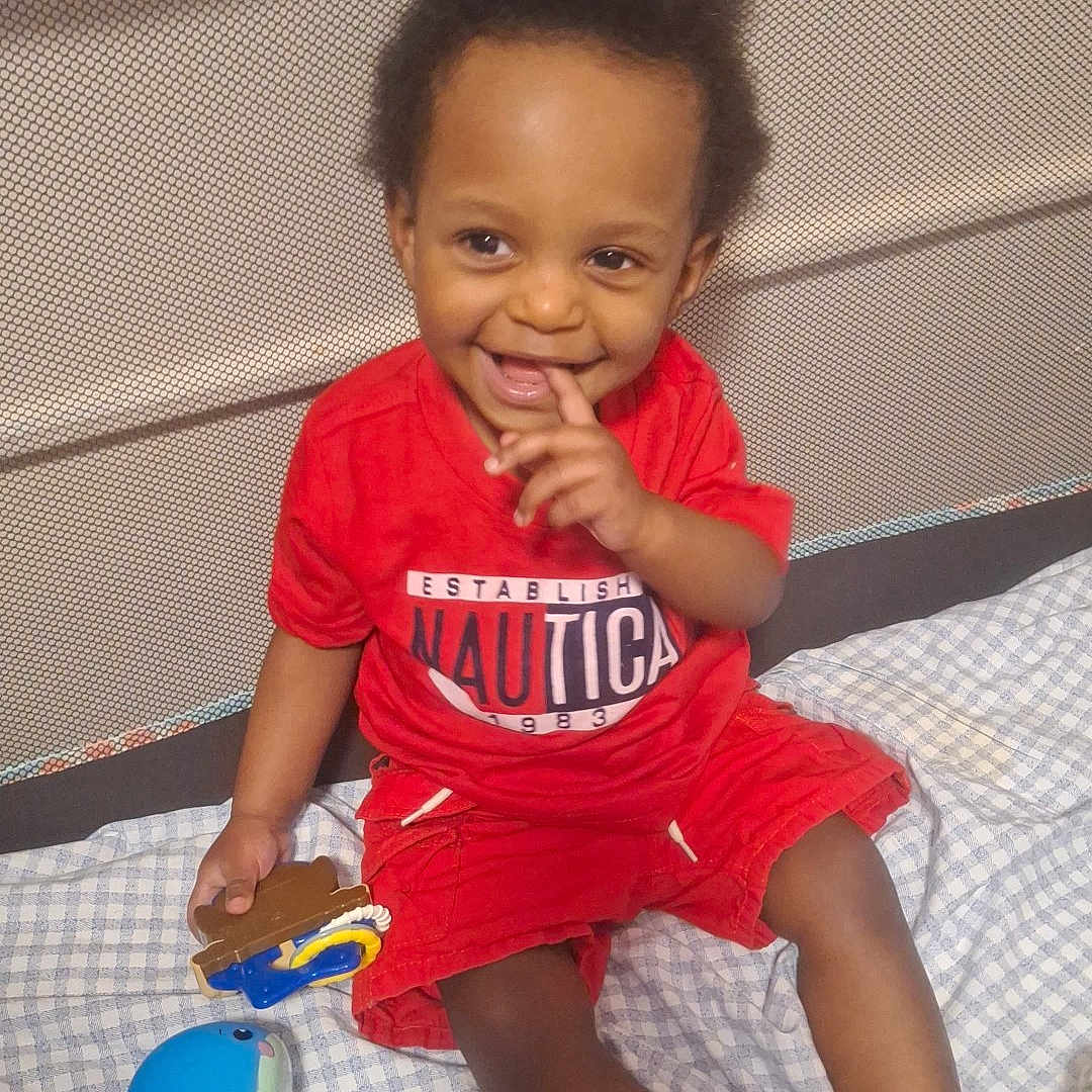 Sohan joined the competition — help win amazing prizes! toddler, child, smiling, red_clothing, toy, playpen, blanket, indoor, happy, person, cute, sitting, baby, feet, hair, face, hand, playtime, nautica, casual