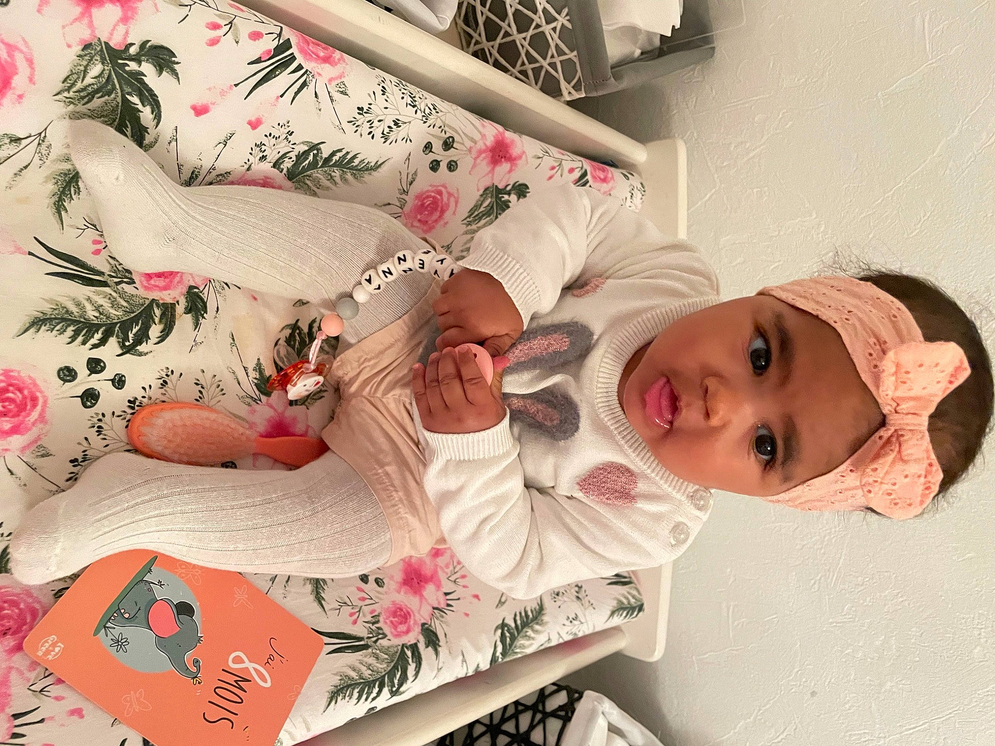 Ayenna participe au concours pour gagner de l'argent avec cette photo : baby, bedding, carmine, child, dress, eye, happy, hat, head, headwear, linens, mammal, pattern, person, pink, room, sleeve, smile, t_shirt, textile