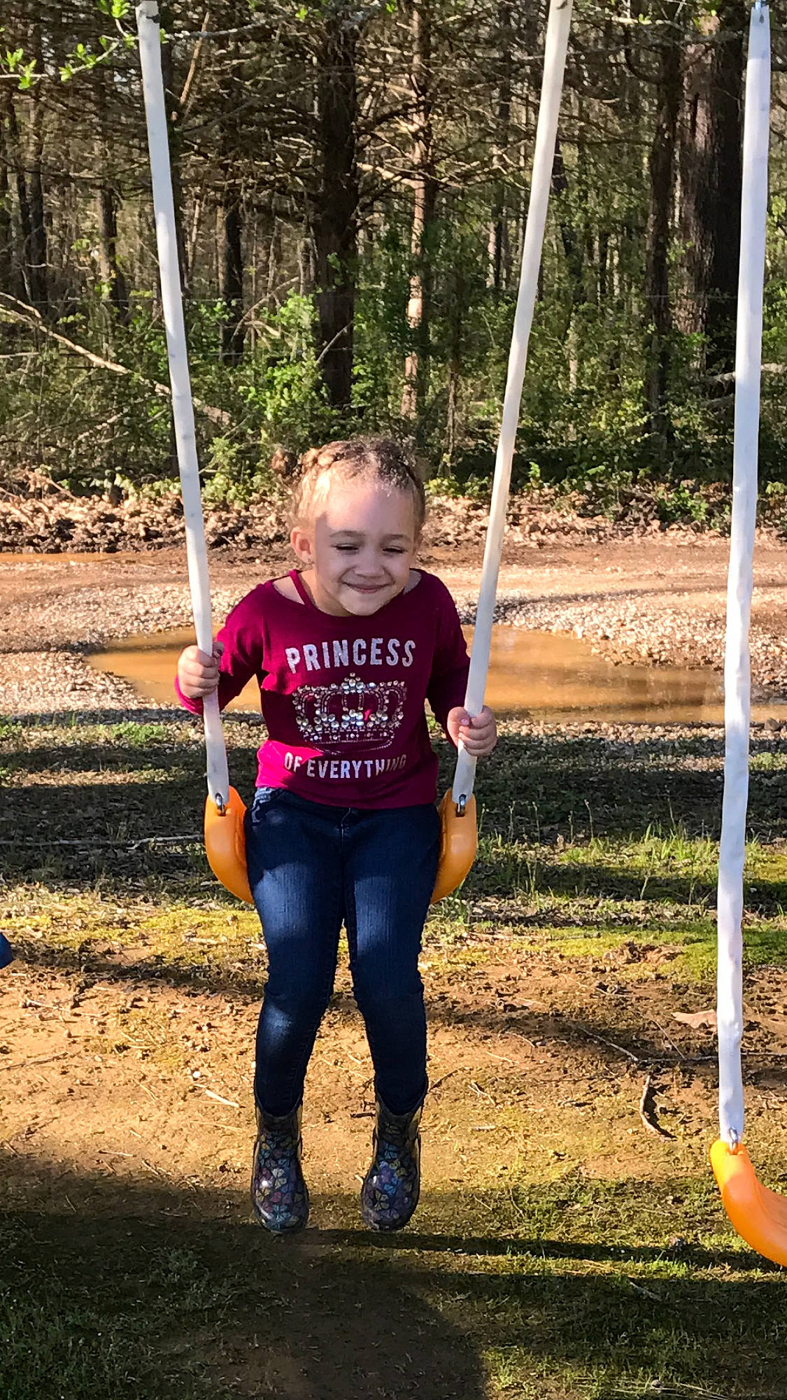 Amyah is registered to the contest to win money with this photo: child, joy, outdoor_play_equipment, person, play, playground, recreation, smile, soil, swing, toddler, tree