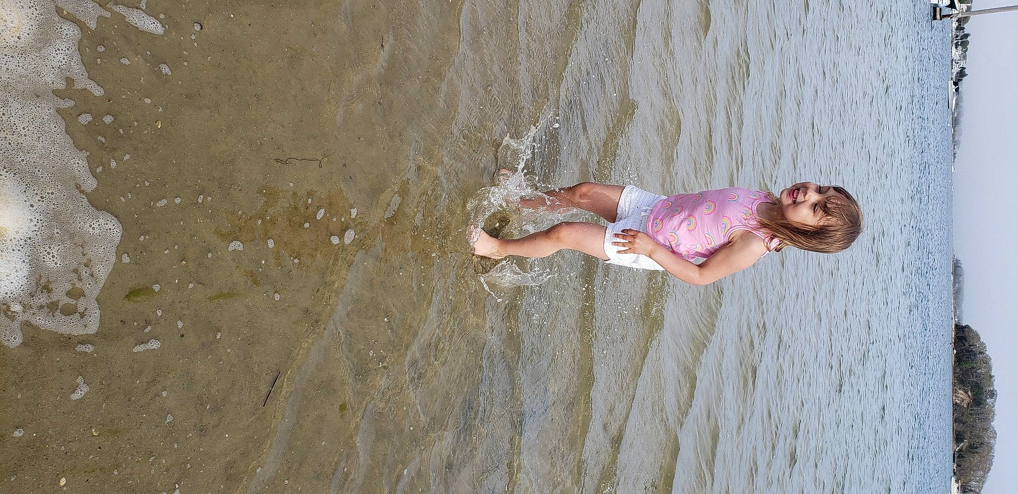 Denise is registered to the contest to win money with this photo: adventure, beach, dress, fun, happy, joy, lake, leg, leisure, people_in_nature, people_on_beach, person, recreation, sand, shorts, smile, sunglasses, tree, water, wave