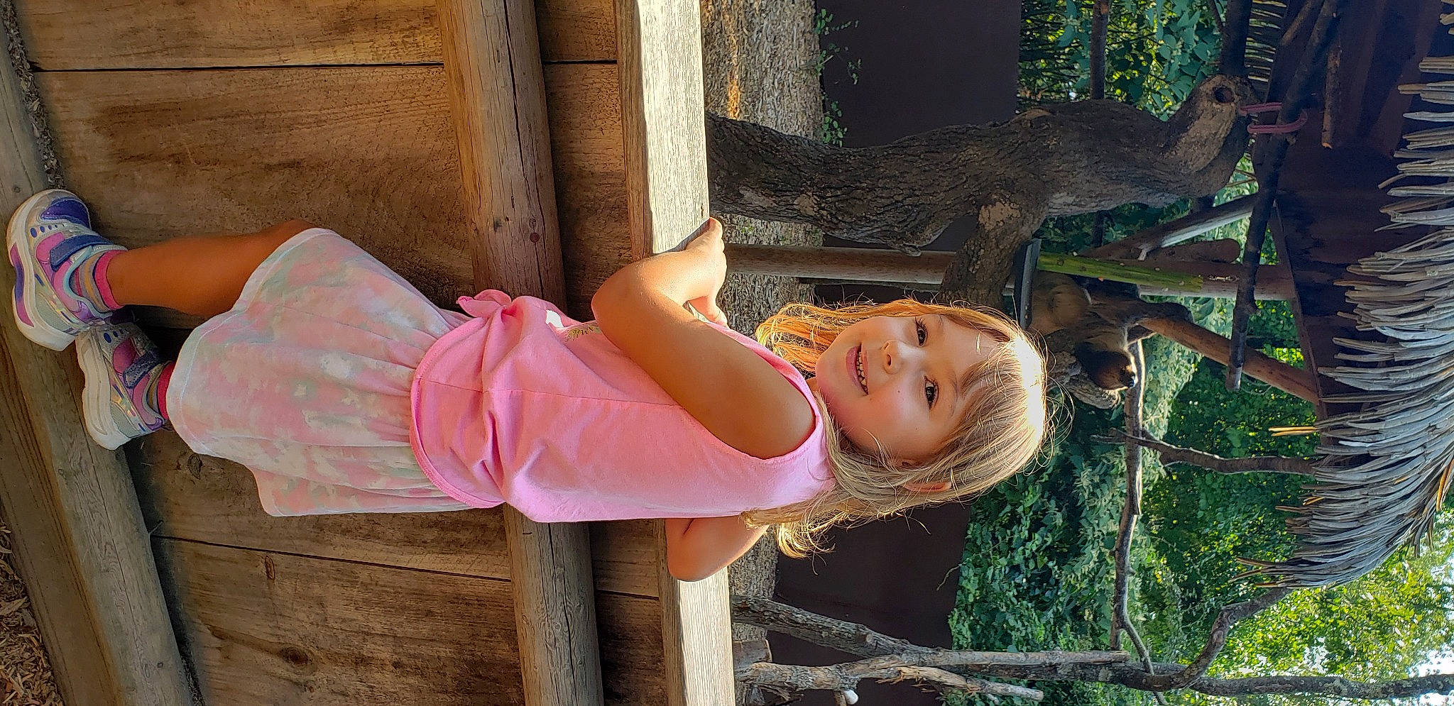 Denise is registered to the contest to win money with this photo: child, eye, fun, grass, happy, human_leg, joy, leisure, magenta, people_in_nature, person, pink, plant, sandal, sitting, skin, smile, thigh, toddler, tree