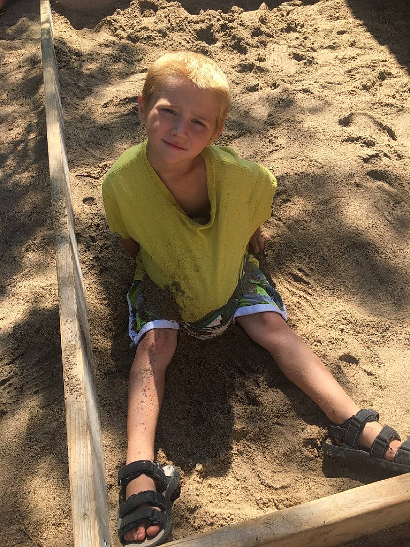 Noah is registered to the contest to win money with this photo: adaptation, adventure, fawn, fun, leisure, person, recreation, sitting, smile, tree, vacation