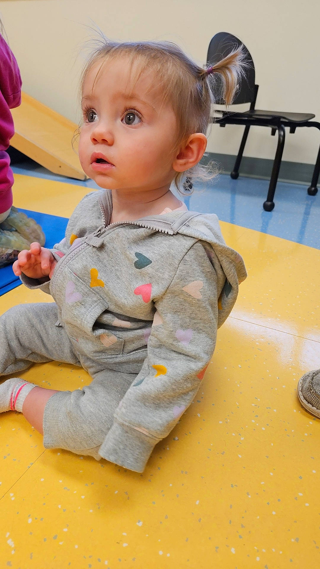 Brelynn is registered to the contest to win money with this photo: baby, bodypart, clothing, face, finger, furniture, hand, hardwood, head, indoors, knitwear, pants, person, photography, plywood, portrait, sitting, sweater, table, wood