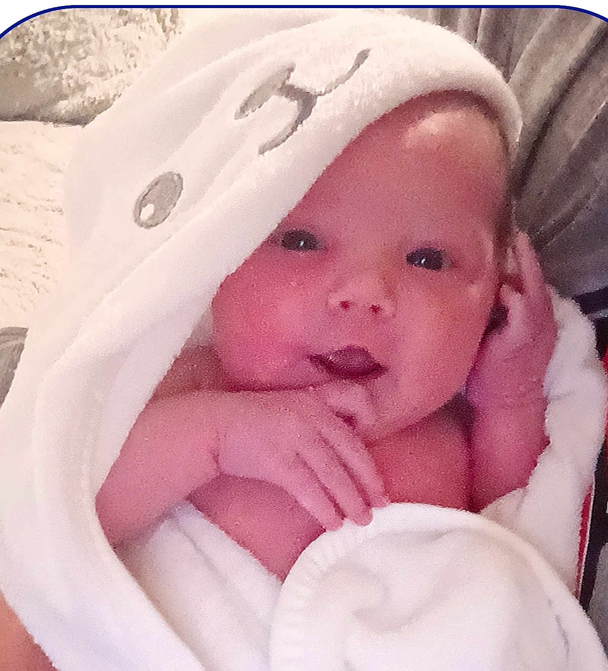 Presley is registered to the contest to win money with this photo: baby, infant, towel, hooded_towel, white_towel, cute, face, hand, skin, newborn, soft_texture, cozy, wrapped, portrait, indoor, child, expressive, pink_skin, looking, closeup