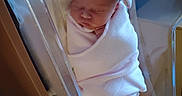 Lilliana joined the competition — help win amazing prizes! newborn, baby, infant, sleeping, blanket, hat, bow, hospital, bassinet, bed, wrapped, cute, peaceful, indoors, person, child, soft, resting, sleep, newborn_baby