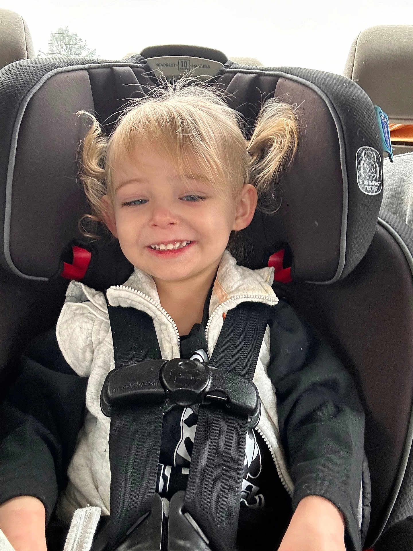 Lainey joined the competition — help win amazing prizes! child, toddler, car_seat, seat_belt, smile, blonde_hair, pigtails, jacket, car_interior, safety, happy, young_child, person, portrait, casual_clothing, cute, seat, baby, travel, car