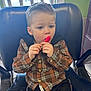 Zachariah joined the competition — help win amazing prizes! child, boy, lollipop, plaid_shirt, brown_shirt, black_chair, indoor, window, blue_eyes, short_hair, sitting, cute, young_child, casual_clothing, hands, face, expression, young_boy, hair, background