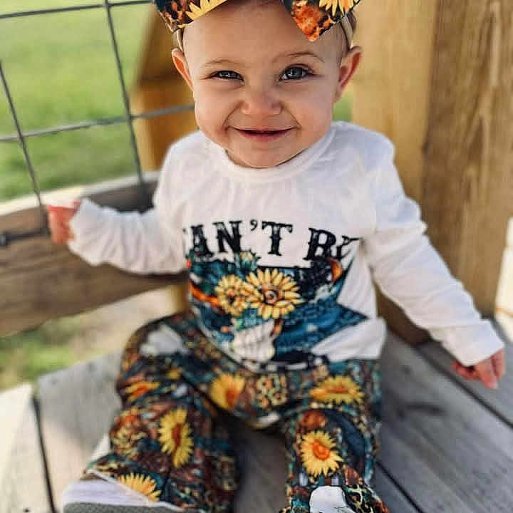 Oaklynn Shea is registered to the contest to win money with this photo: baby, babylaughing, beachwear, boy, child, clothing, dimples, face, hair, happy, head, jeans, male, pants, person, photography, portrait, sitting, sleeve, smile