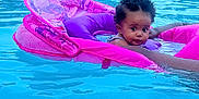 Iyla joined the competition — help win amazing prizes! baby, pool, floatie, water, swimming, child, summer, outdoor, person, blue, pink, curly_hair, infant, hand, relaxation, leisure, poolside, daylight, safety, fun