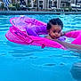 baby, pool, floatie, water, swimming, child, summer, outdoor, person, blue, pink, curly_hair, infant, hand, relaxation, leisure, poolside, daylight, safety, fun
