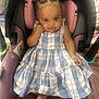 Iyla joined the competition — help win amazing prizes! baby, child, car_seat, dress, braided_hair, beads, smile, indoor, cute, footwearless, infant, portrait, person, seat, plush, happy, skin, clothing, head, eyes