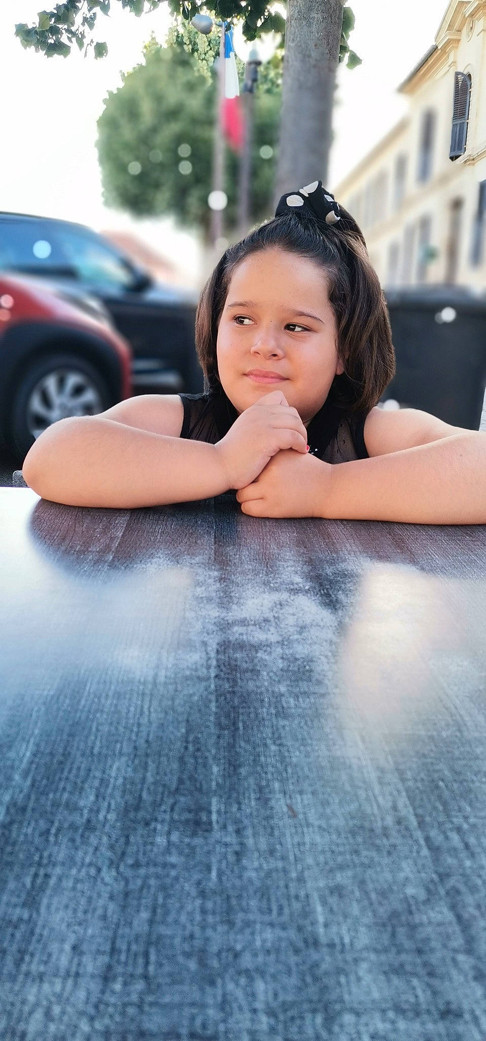 Léna a rejoint le concours — aidez-le/la à gagner de superbes lots ! asphalt, automotive_tire, black_hair, car, cool, facial_expression, finger, flash_photography, floor, flooring, gesture, hand, happy, leisure, person, shoulder, tire, toddler, tree, wheel