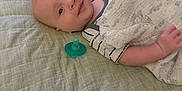 Ledger joined the competition — help win amazing prizes! baby, infant, bed, blanket, pacifier, quilt, sleepwear, child, face, skin, head, lying_down, room, indoor, comfort, soft, person, cute, young, resting
