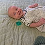 Ledger joined the competition — help win amazing prizes! baby, infant, bed, blanket, pacifier, quilt, sleepwear, child, face, skin, head, lying_down, room, indoor, comfort, soft, person, cute, young, resting