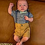 baby, child, infant, bow_tie, suspenders, shorts, shirt, leather_couch, footwear, barefoot, person, portrait, indoor, curious, cute, fashion, legs, carpet, raised_fist, blue_shirt